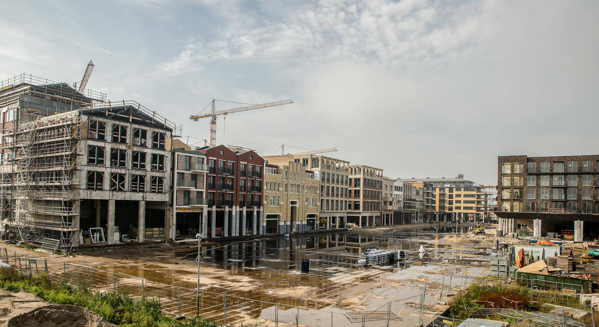 A modern construction site with buildings and cranes showcasing urban development.